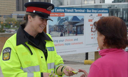 Female officer happily talking to a female on the street